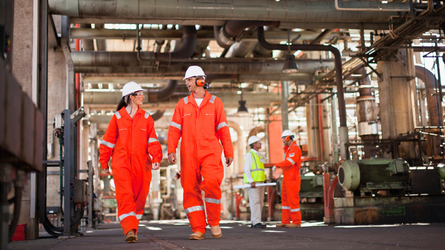 Man and woman walking at petrochemical site