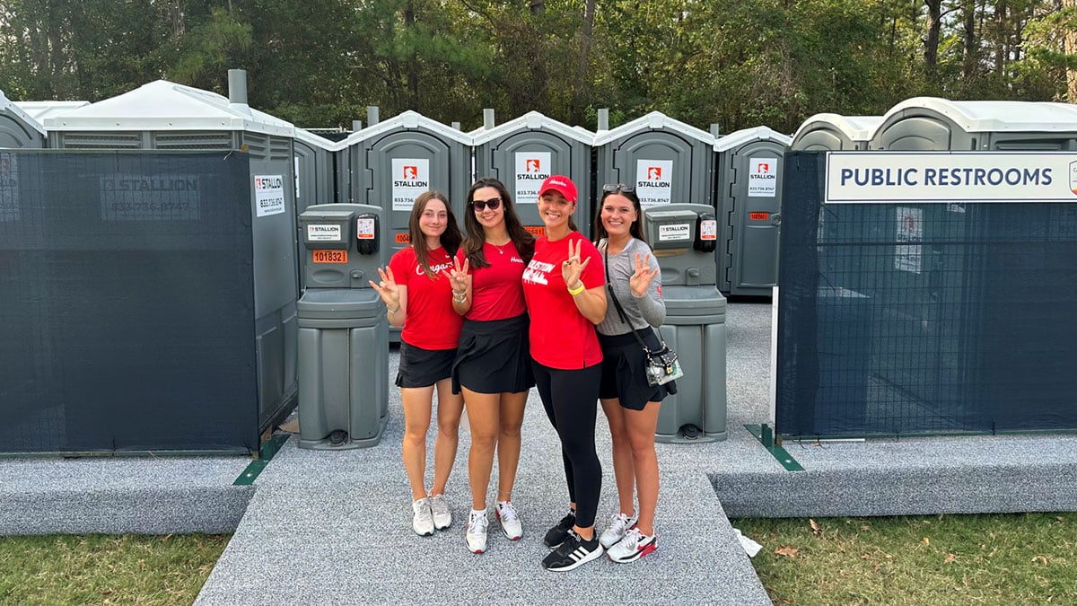 UH Ladies Golf in front of Stallion Portable Restrooms at Houston Open