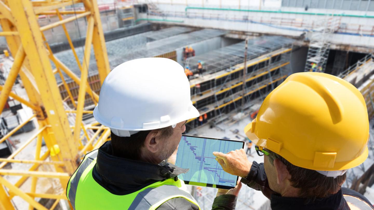 Men on construction site with crane